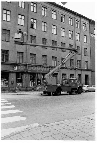 The city administration replaces light bulbs in the street lights with a sky lift, Stockholm. (1970)